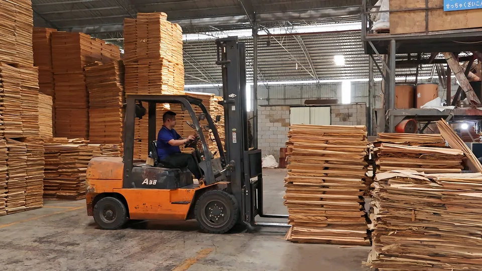 Forklift handling plywood raw material in the workshop